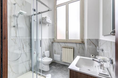 a bathroom with a toilet and a sink and a shower at Hotel Ottaviano Augusto in Rome