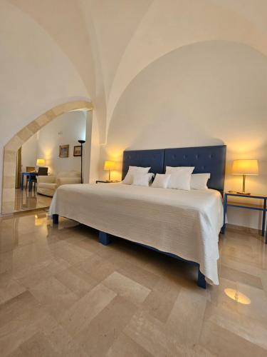 a bedroom with a large bed in a room at Antica Masseria Torre Mozza in Torre Santa Susanna