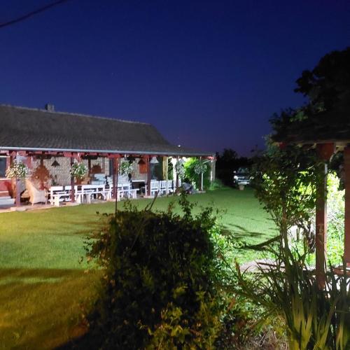 a house with a green yard at night at Imanje sa bazenom in Obrenovac