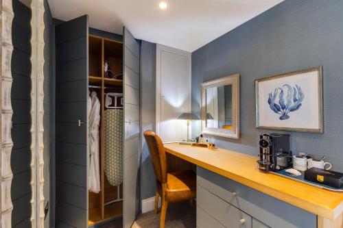 a bathroom with a desk and a chair in a room at The Swan Hotel and Spa in Newby Bridge