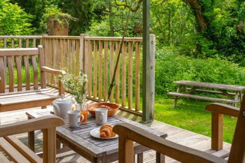 a wooden table with bread on a wooden deck at Moorhen - Exton Park in Exton