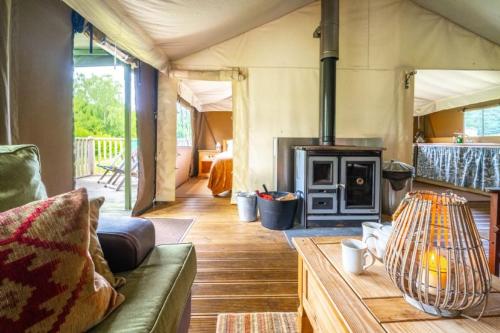a living room with a couch and a stove at Moorhen - Exton Park in Exton
