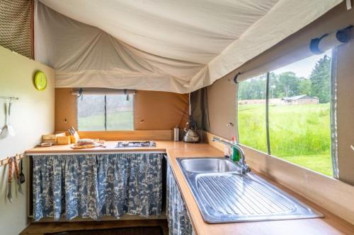 a kitchen in a camper with a sink and a window at Moorhen - Exton Park in Exton