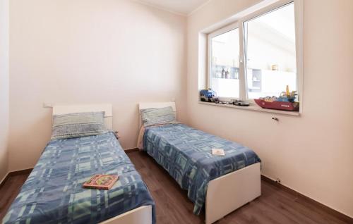 a bedroom with two beds and a window at Villa Al Monte in Mondragone
