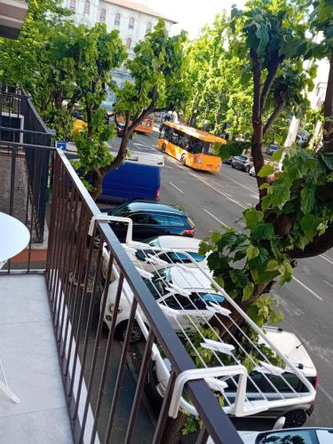 a balcony with a bunch of chairs and a street at KeyRooms in La Spezia