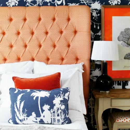 a bed with an orange headboard and a blue and white pillow at The Swan Hotel and Spa in Newby Bridge