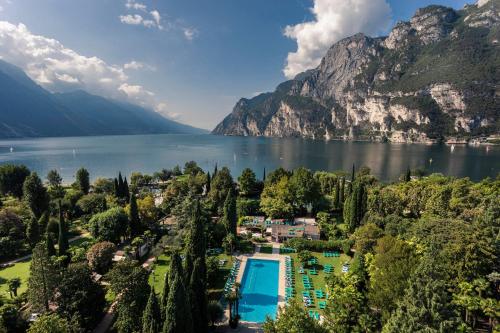 arial view of a resort on a lake with mountains at Du Lac Et Du Parc Grand Resort in Riva del Garda
