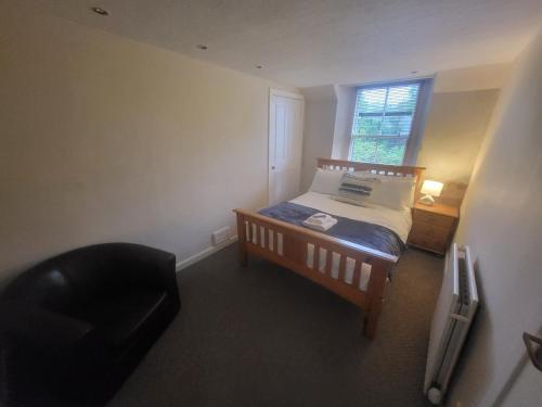 a small bedroom with a bed and a window at THE Waterloo Arms Hotel in Chirnside