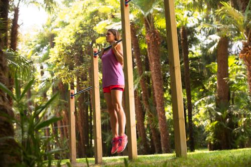 a girl is on a pole in a park at Du Lac Et Du Parc Grand Resort in Riva del Garda