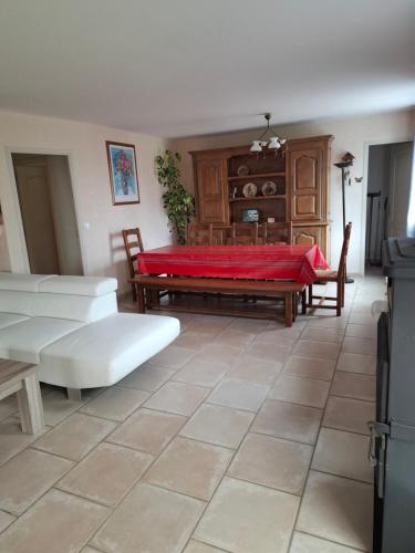 a living room with a couch and a table at campagne in Saint-Pardoux-le-Neuf