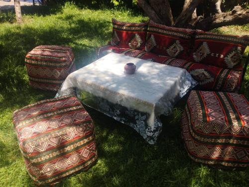 a table and chairs with a vase on top of it at Villas khadija in Marrakech
