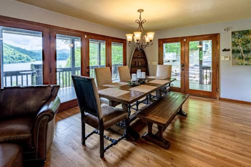 a dining room with a wooden table and chairs at Lakefront Point Retreat on Nantahala Lake with Dock in Topton