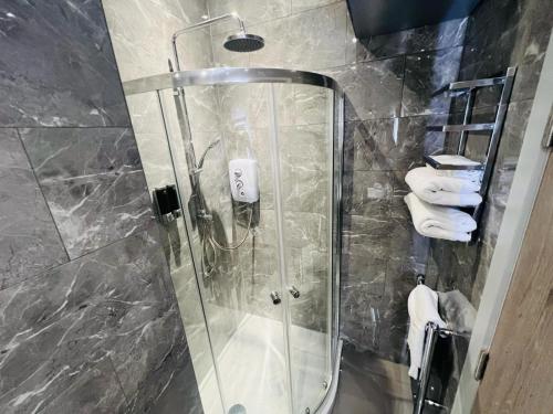 a shower with a glass door in a bathroom at WhiskAwayStays - Foregate Street - Apartment 1 in Worcester