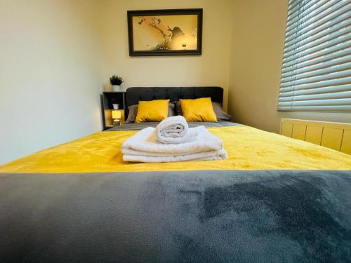 a room with a bed with a towel on it at WhiskAwayStays - Foregate Street - Apartment 1 in Worcester