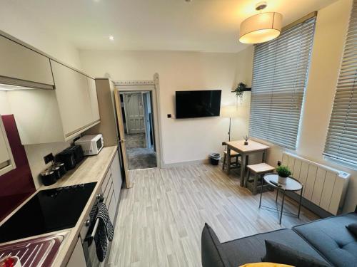 a living room with a couch and a table at WhiskAwayStays - Foregate Street - Apartment 1 in Worcester
