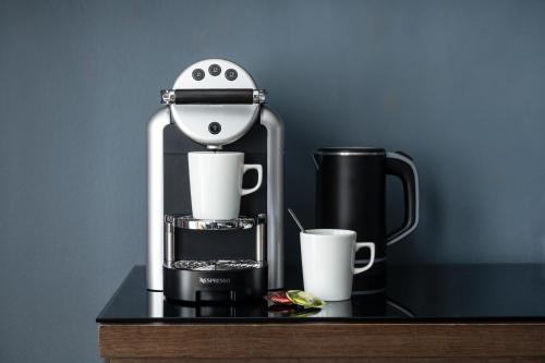 a coffee maker sitting on a table with a cup at St Martins Lodge in Leicester