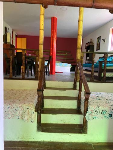 a staircase leading to a living room with a table at Finca hotel tierra grata in Montenegro