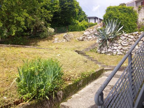 a set of stairs leading up to a yard with a plant at Albergo Alla Posta in Anduins