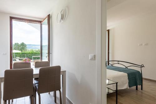 a bedroom with a bed and a table and chairs at Agriturismo Pian del Vescovo in Massa Marittima