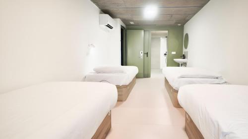 a row of beds in a hospital room at Ideal Youth Hostel in Barcelona