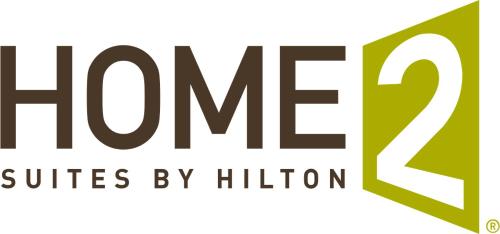 a logo for the hmc clinics by religion at Home2 Suites By Hilton Lake Jackson in Lake Jackson