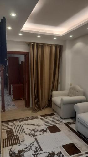 a living room with a couch and a television at Seuiet Hs شهاب in Cairo