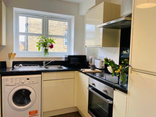 a kitchen with a sink and a washing machine at Endsleigh Park in Hull