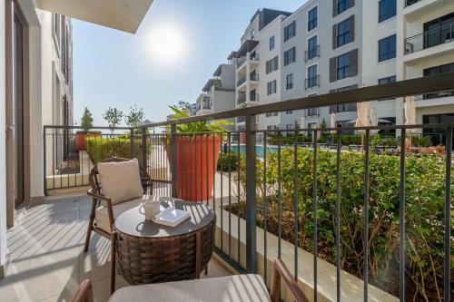 a balcony with a table and chairs and a building at GuestReady - Stylish blue elegance in La Cote in Dubai