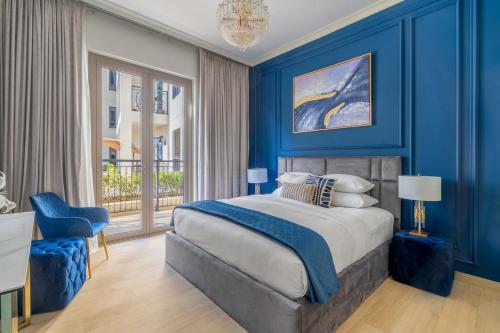 a blue bedroom with a bed and a blue wall at GuestReady - Stylish blue elegance in La Cote in Dubai