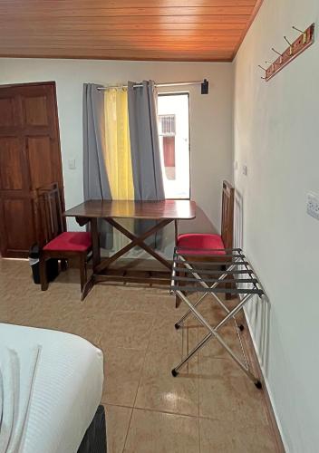 a room with a table and two chairs and a window at Casa Jungle Monteverde B&B in Monteverde Costa Rica