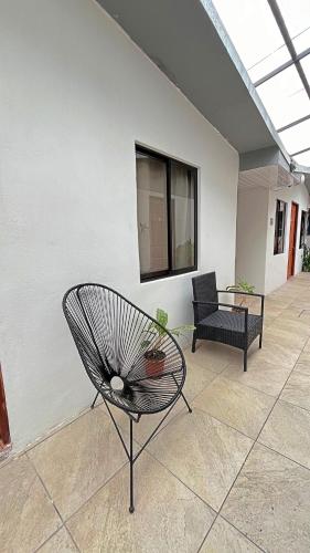 a patio with a bench and a chair and a window at Casa Jungle Monteverde B&B in Monteverde Costa Rica