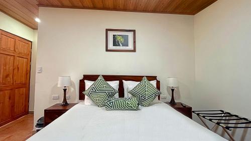 a bedroom with a large bed with two lamps on tables at Casa Jungle Monteverde B&B in Monteverde Costa Rica