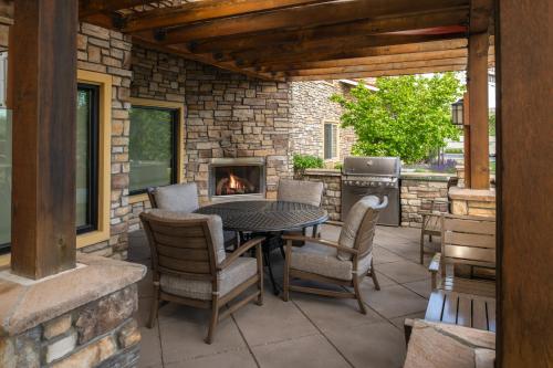 a patio with a table and chairs and a fireplace at TownePlace Suites Richland Columbia Point in Richland