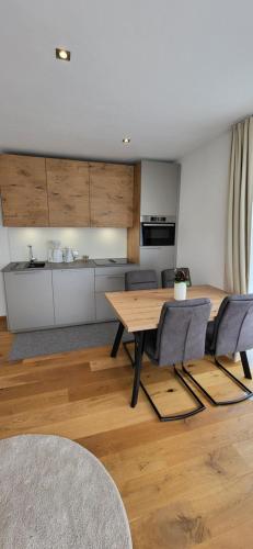 a living room with a wooden table and chairs at Villa Juwel in Altenmarkt im Pongau