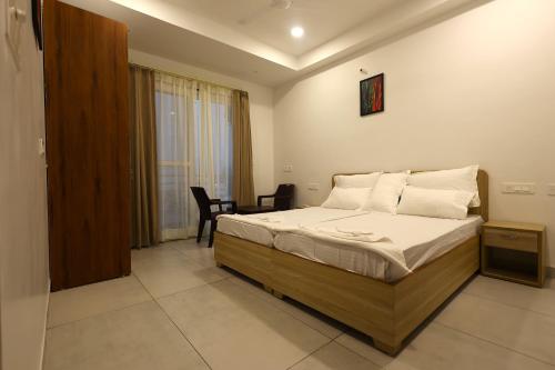 a bedroom with a bed and a table and chairs at Unio Mystica in Rishīkesh