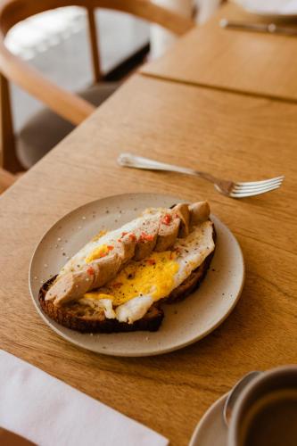 a plate with an egg sandwich on a table at La Posada del Puente in Arequipa
