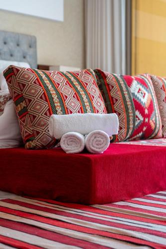 a red bed with pillows on top of it at Tayyurt host in Agadir