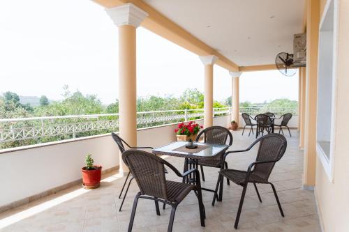 a patio with chairs and a table on a balcony at Apartments Vasileiou Suite 4 in Preveza