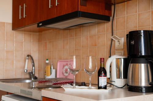 two wine glasses sitting on a counter in a kitchen at Apartments Vasileiou Suite 4 in Preveza