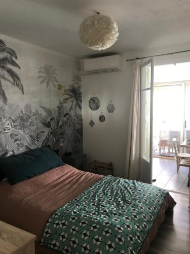 une chambre avec un lit avec une couverture verte dans l'établissement Grande terrasse proche Cours Julien, à Marseille
