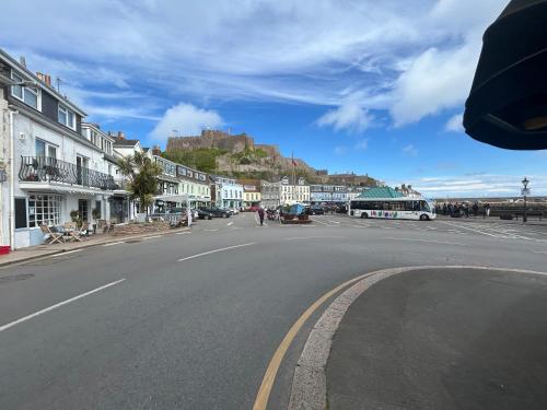 a bus driving down a street with a castle in the background at Gorey retreat main house in Gorey