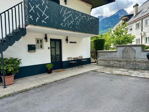a house with a black and white facade with a patio at Alpine Echo Apartments in Bovec