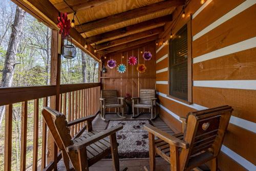 a porch of a cabin with two rocking chairs at Cozy Bears Cabin by Eden Crest in Pigeon Forge