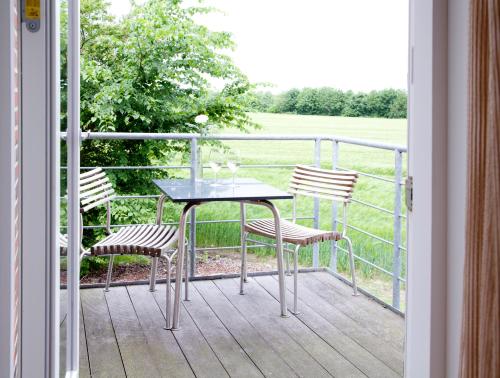 a table and two chairs sitting on a balcony at Montra Hotel Sabro Kro in Sabro