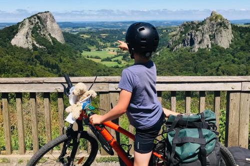 a young boy on a bike with a teddy bear at Gîte au Bray in Bellenaves
