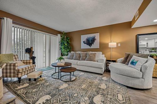 a living room with two couches and a table at Bearadise Mountain Getaway by Eden Crest in Sevierville