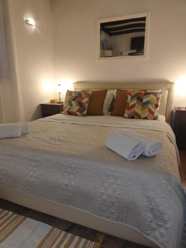 a bedroom with a large bed with two towels on it at Apartment Astoria in Krilo