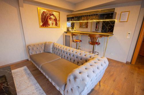 a living room with a couch in a room at Vivaldi Park Hotel in Ankara