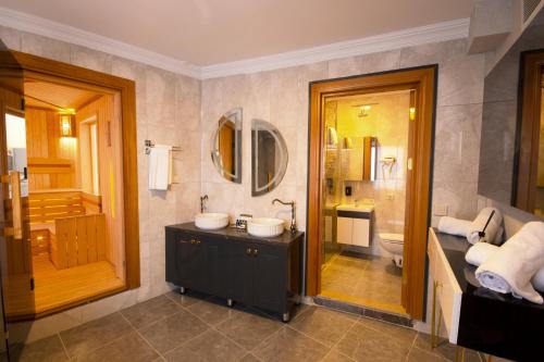 a bathroom with a sink and a toilet and a tub at Vivaldi Park Hotel in Ankara