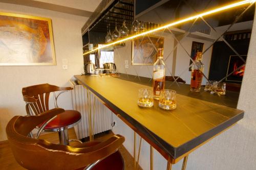 a bar with wine glasses and bottles on a counter at Vivaldi Park Hotel in Ankara